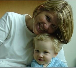 Kelly hugs a smiling Jackson in the hospital