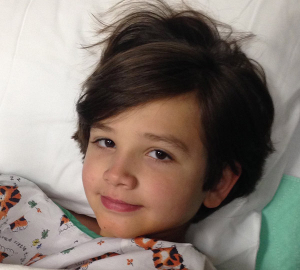 Luke lying in a hospital bed shortly after he was diagnosed with acute lymphoblastic leukemia