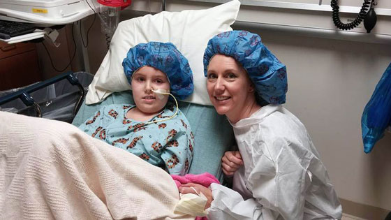 Avery and Stephanie dressed in their scrubs in the hospital