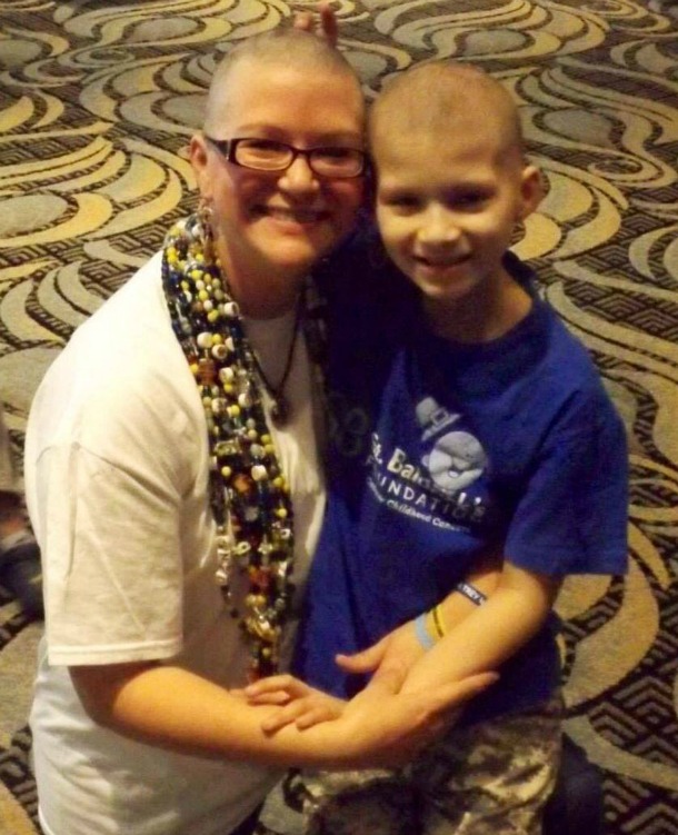 Kristi and Julian hug each other after they both shaved for St. Baldrick's