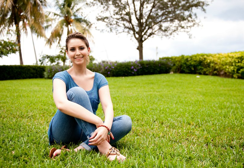 Ambassador Lauren sits in the grass