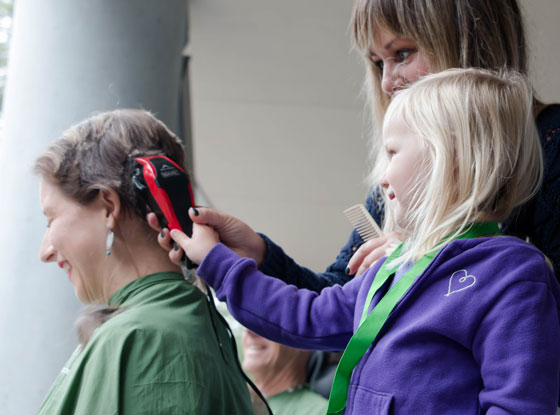 Aurora helps shave Katrina's hair at UC Santa Cruz