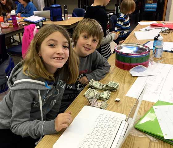 two students count money raised daily