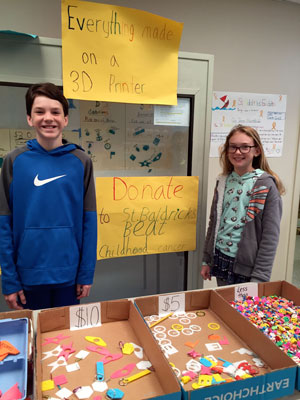 two students sell items to raise money