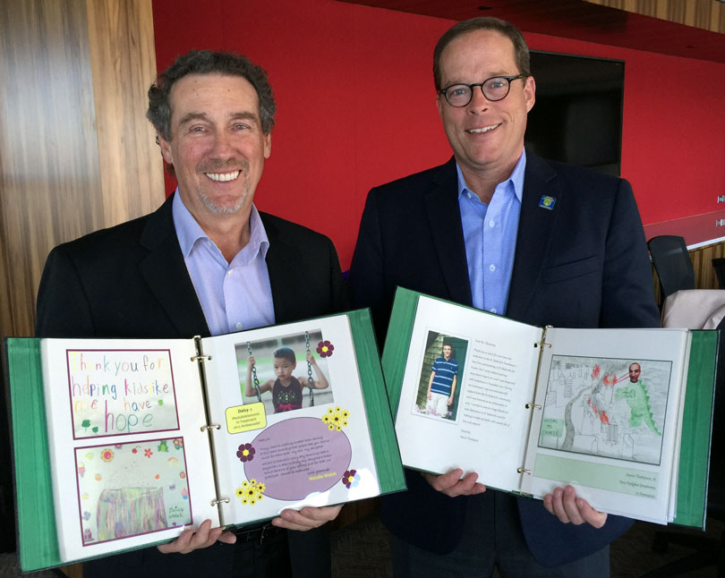 Joe Bartlett and Chuck Chamness holding books