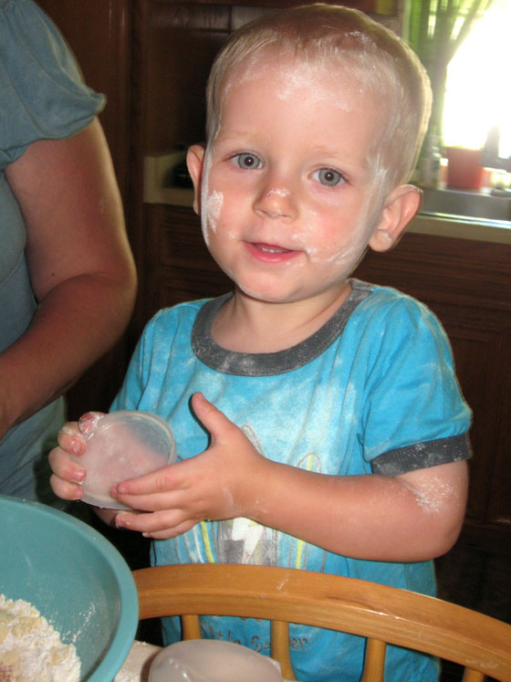 Caemon baking with flour on his face