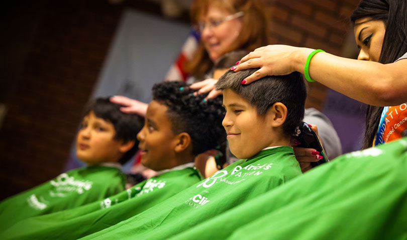 Three boys shaving their heads