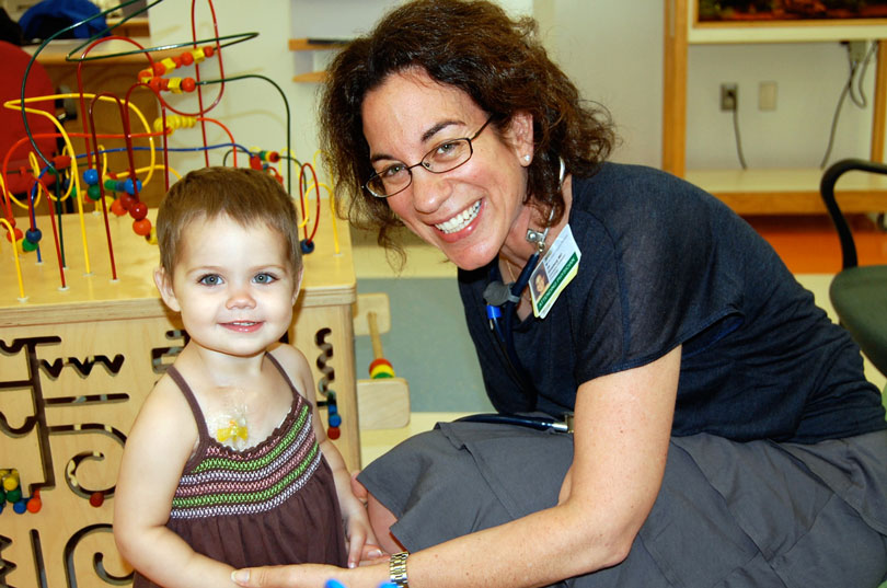 Dr. Jill Ginsberg smiles with child