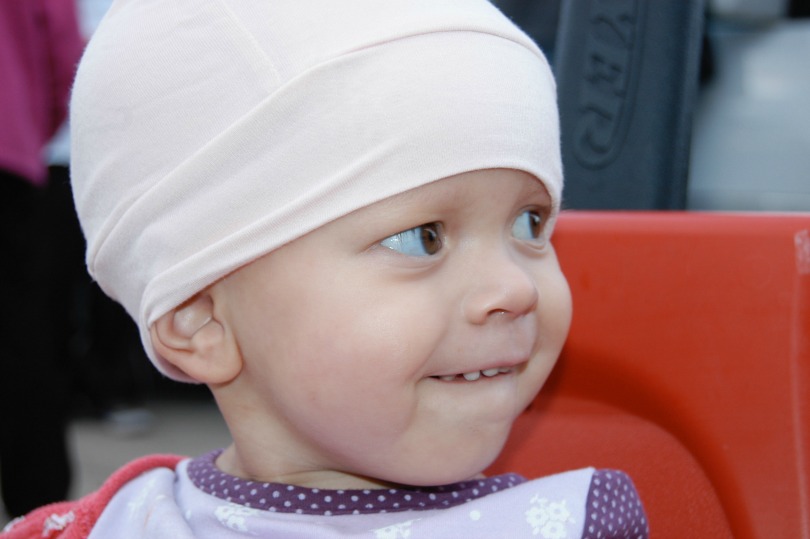 Tuesday smiles while wearing a white hat