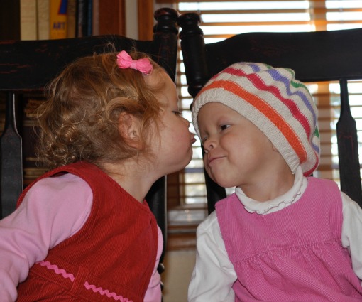 Tuesday and her twin, Piper, share a kiss