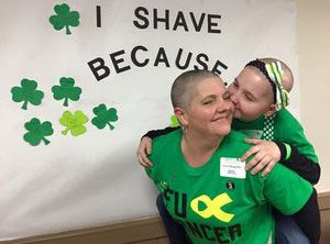 Zayla kisses her mom, Chris, after she shaved with St. Baldrick's