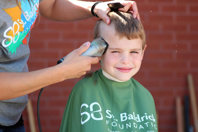 Young boy getting his head shaved