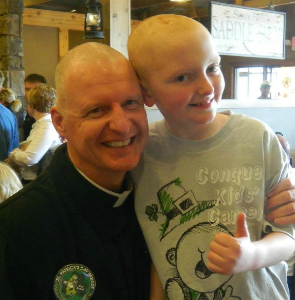 Ian smiles and gives a thumbs up with his friend Father Morgan after their shave