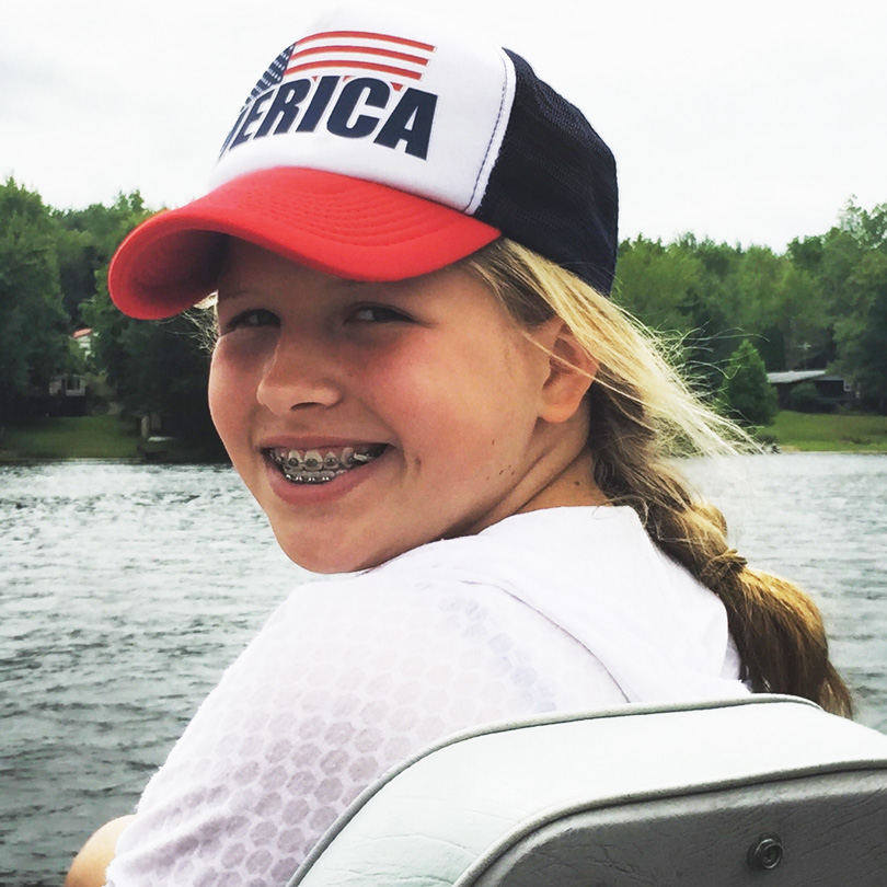 Sara smiles while boating