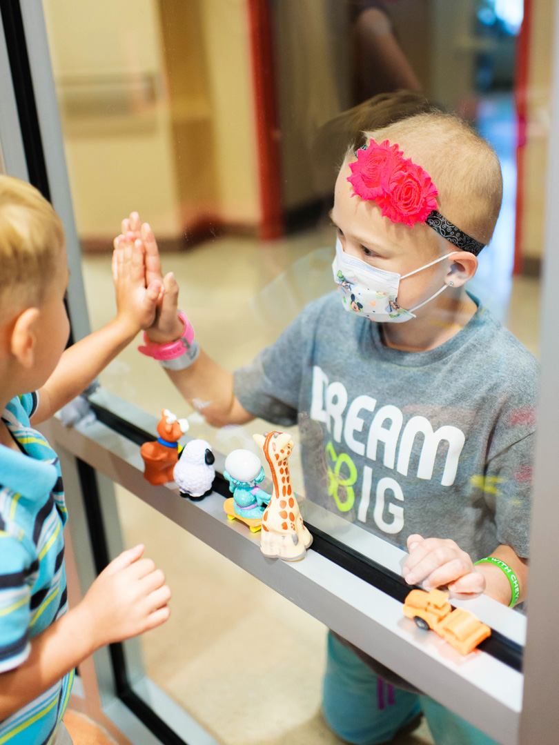 Cheyenne and Tristen hands between glass