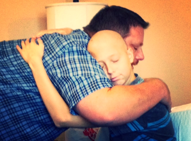 Mitch hugs his dad