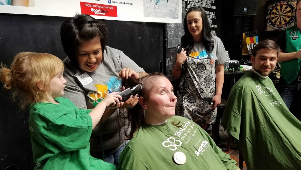 April Prussak helps an Honored Kid shave a head