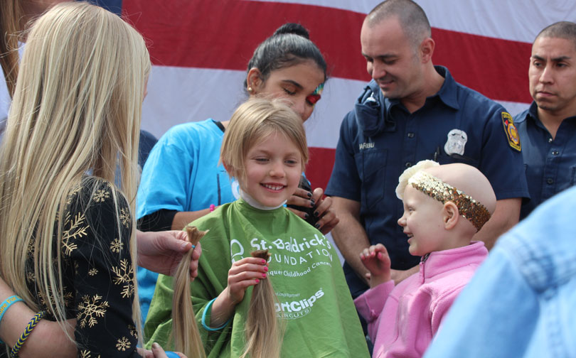 Hazel helps shave Lindsey's head