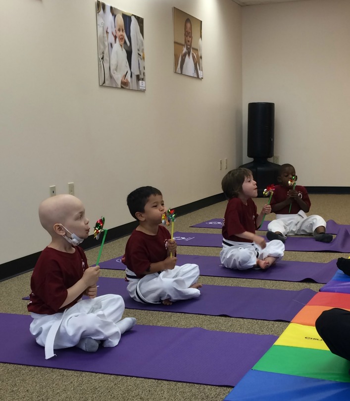 Kids with cancer do a breathing exercise