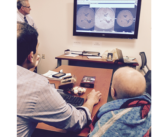 Chase and Dr. Lulla look at brain scans