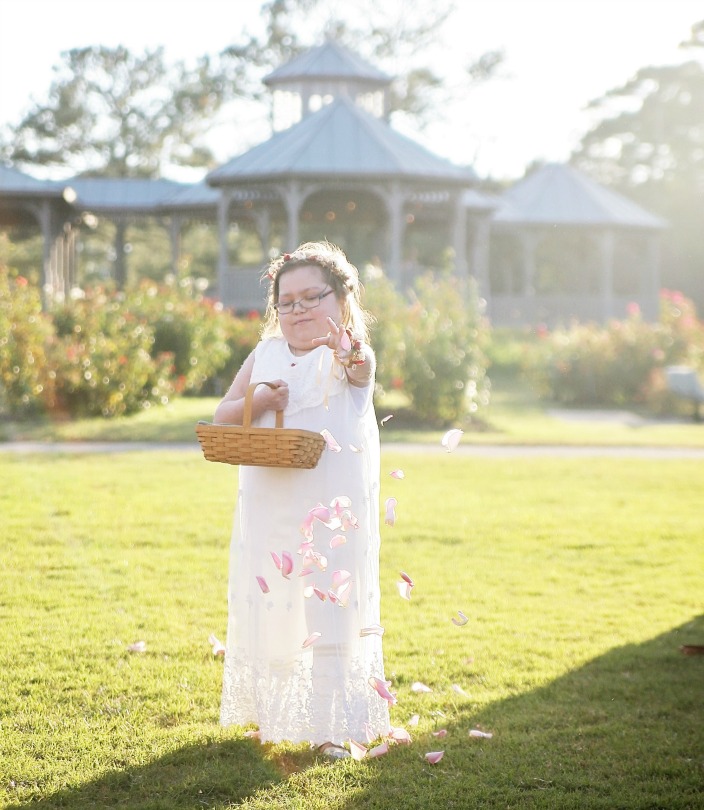 Abby tosses flowers as the flowergirl