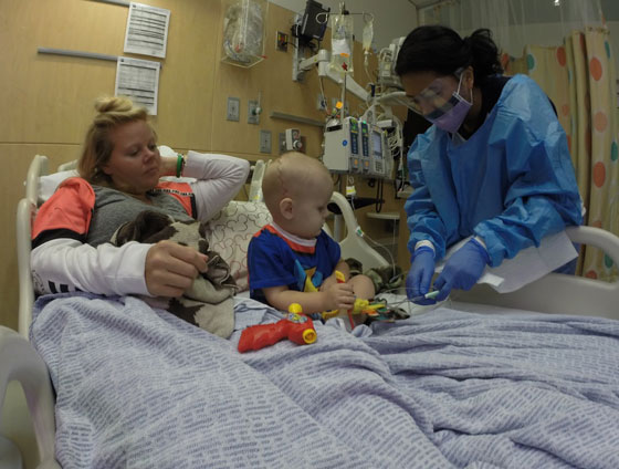 atticus and his mom in a hospital bed