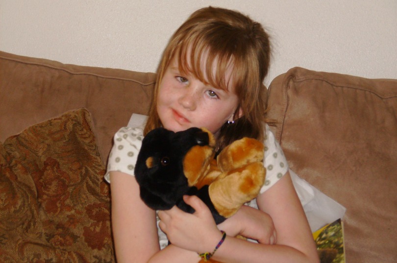 Kylee hugs a stuffed animal