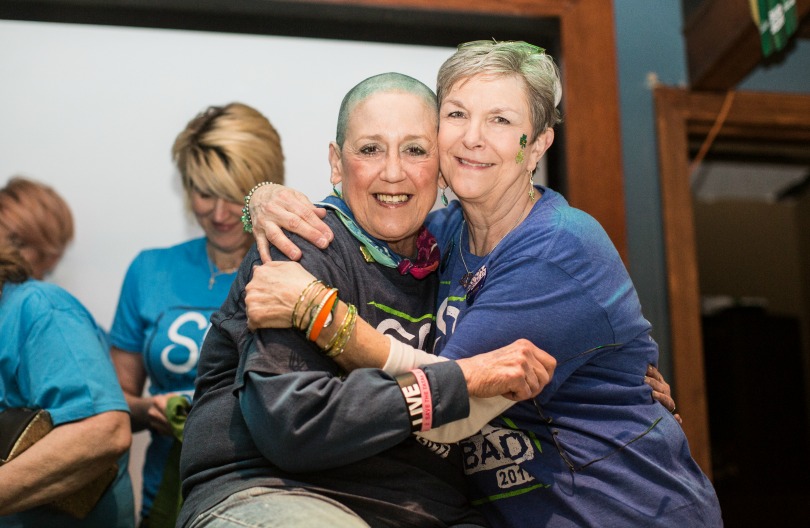 Peggy hugs shavee and fellow nurse Mona