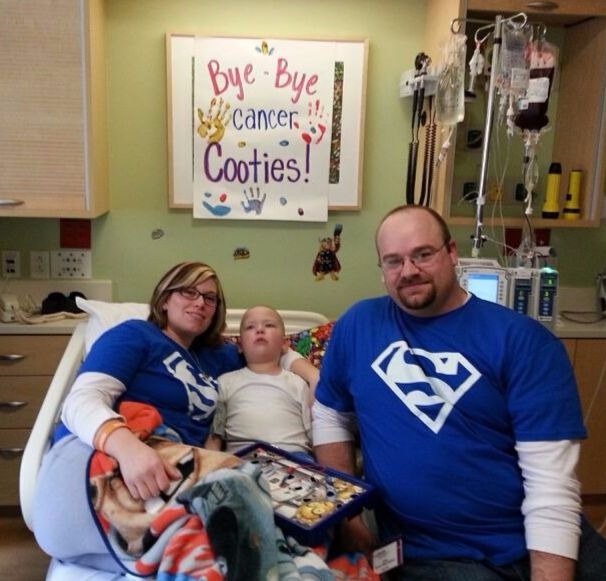 Austin and his family share a moment in his hospital room