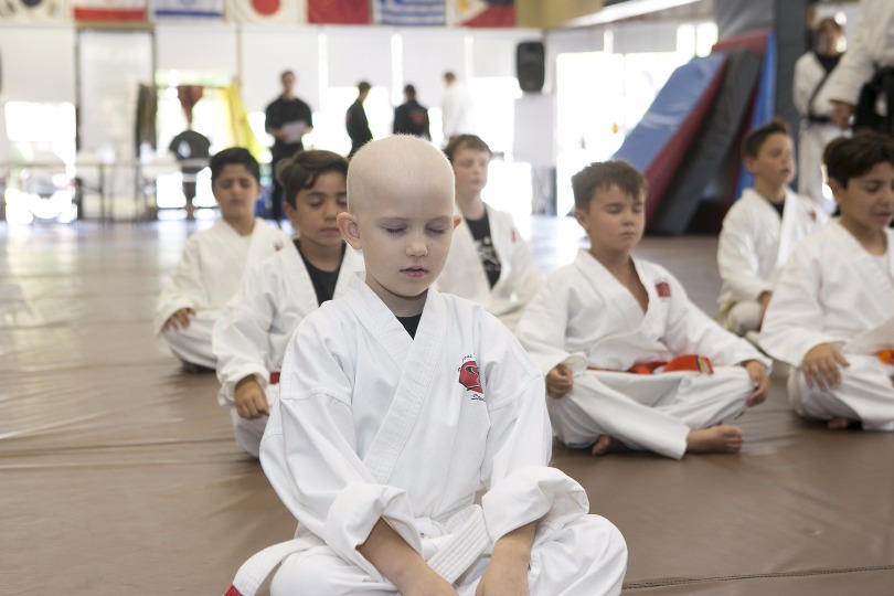 Grace meditates during karate class