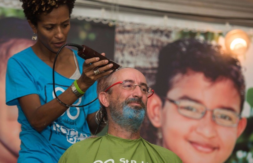 Team captain Eugene shaves for St. Baldrick's