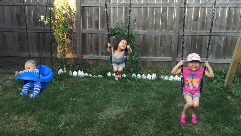 Ava and her siblings on the swings