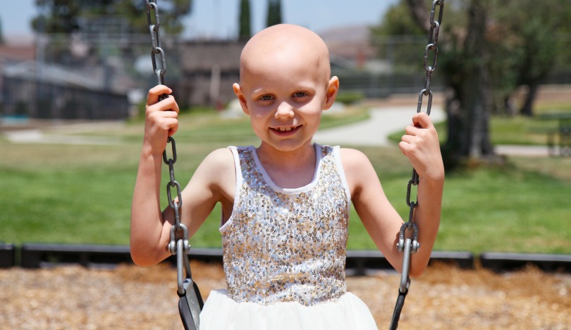 Hazel plays on the swings at the park