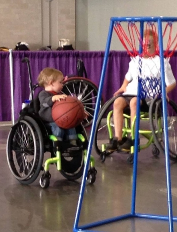 Kellan playing wheelchair basketball