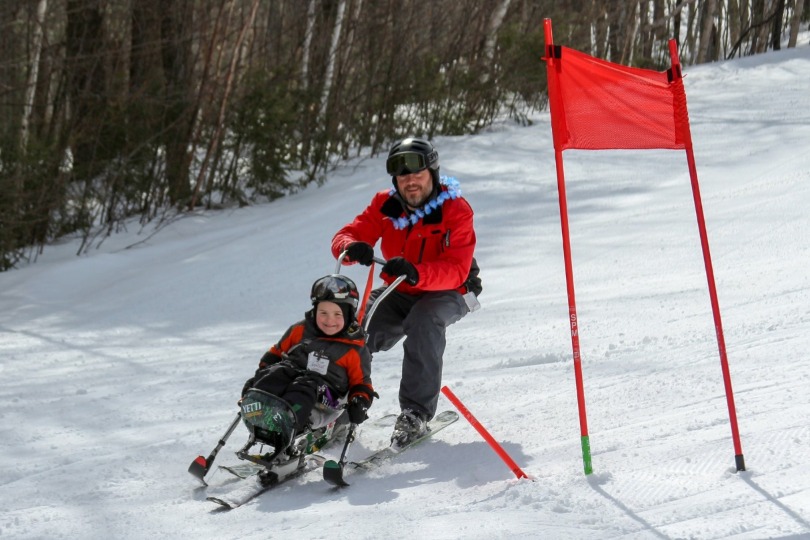 Dan guides Kellan on the ski slope