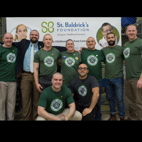 University of New England Rocks the Bald Event Logo